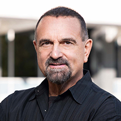 Headshot of George D. Yancopoulos, M.D., Ph.D. wearing a black shirt.