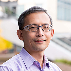 Headshot of John Lin, MD, PhD wearing a blue shirt