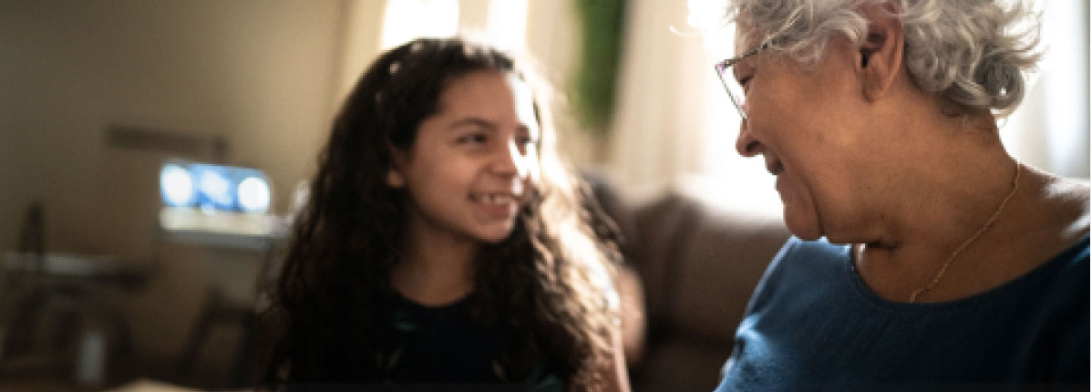 An elderly woman talking to her grandchild.