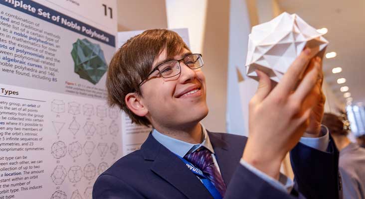 2026 Regeneron Science Talent Search winner Connor Hill holding a noble polyhedron