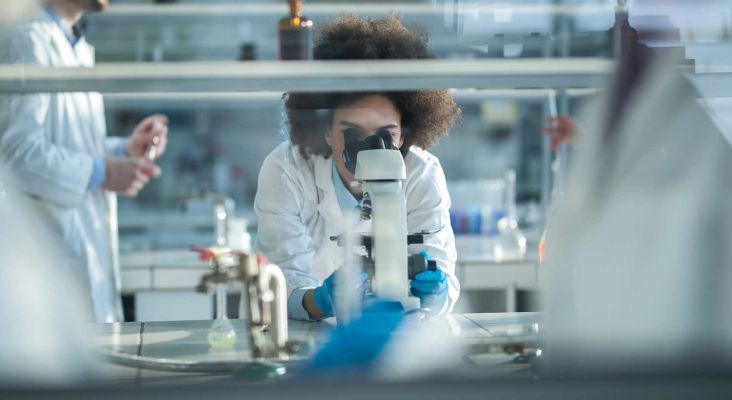 Scientist looking under microscope