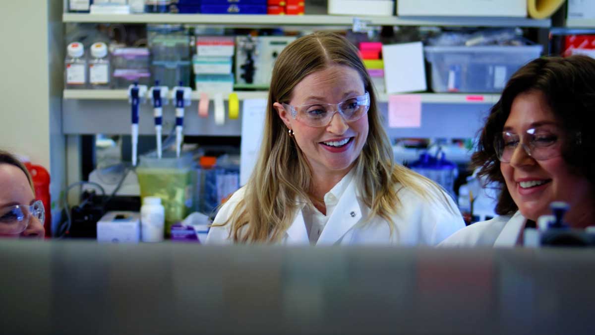  Regeneron Genetics Center scientist smiling with coworker in lab
