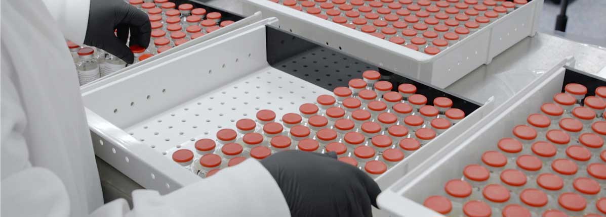 Technician working with glass vials