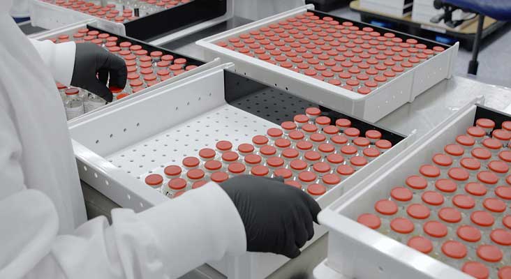 Technician working with glass vials