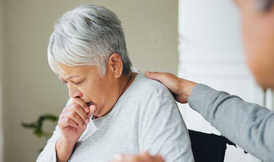  Woman in grey shirt coughing