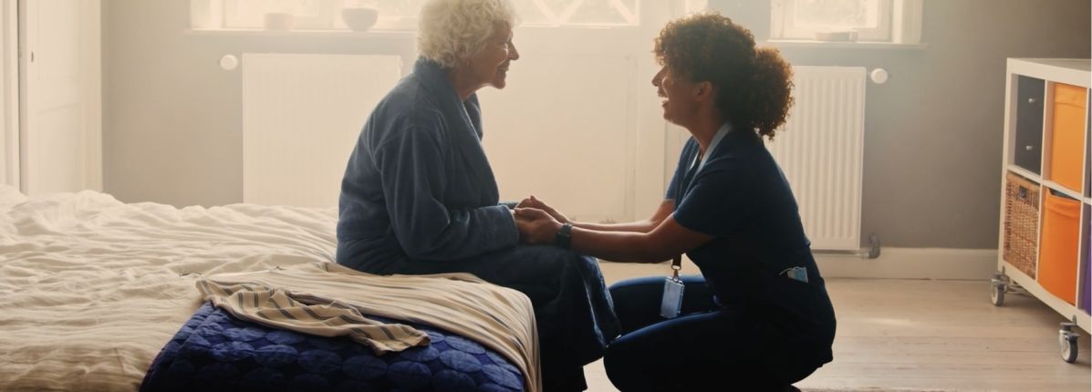 Cancer patient smiling and speaking to her doctor