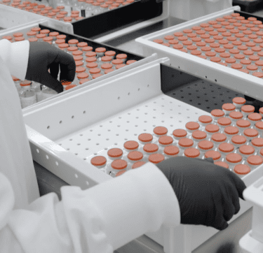 Technician working with glass vials