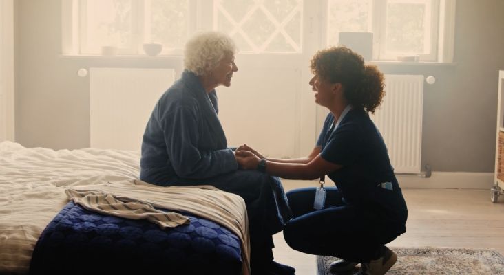 Cancer patient smiling and speaking to her doctor