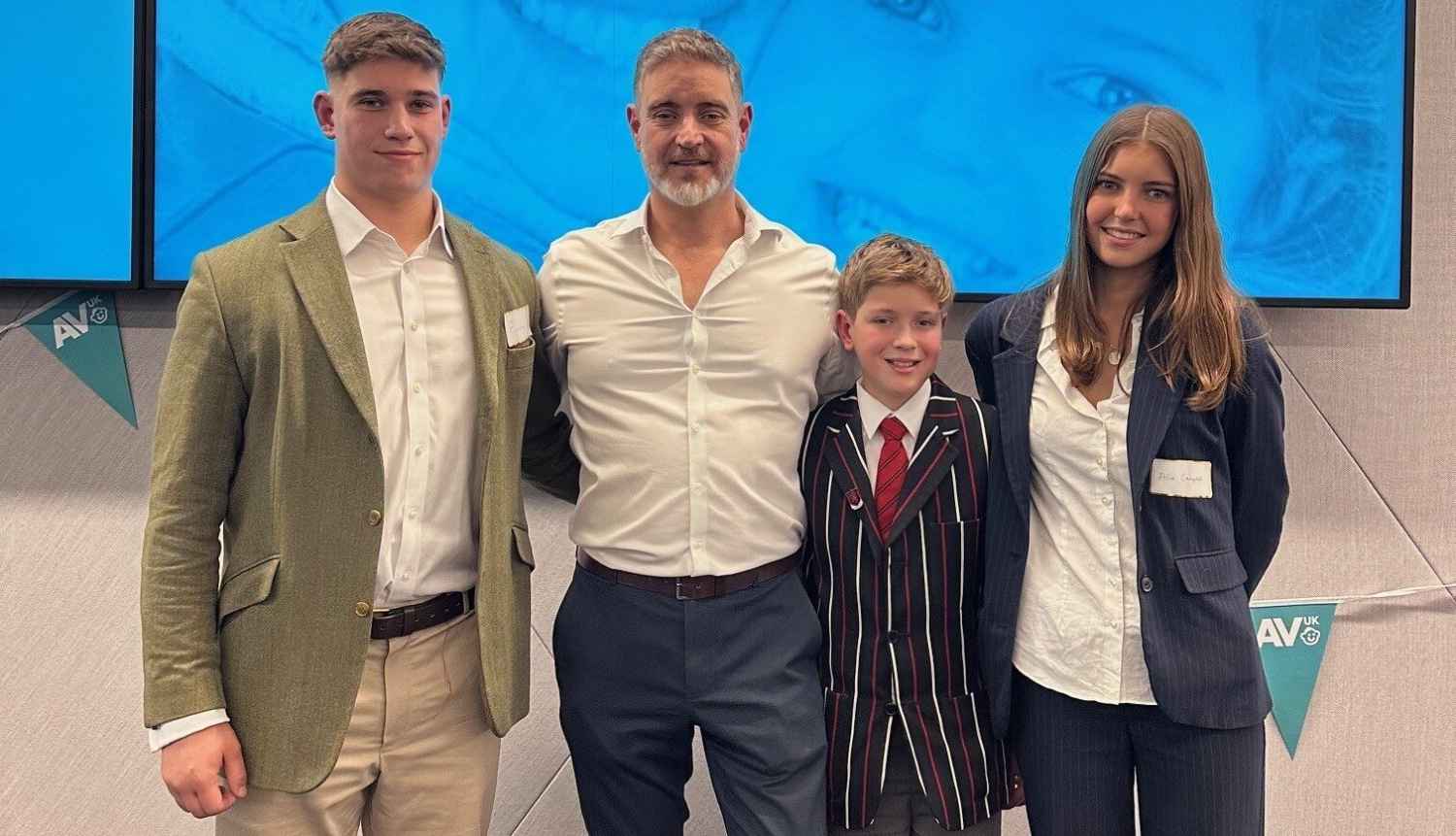 The Campbell family standing together and smiling.