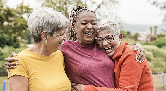 3 individuals embracing one another