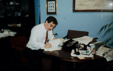  Man working at desk compiling lab research