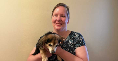  Jennifer Crowell smiling and holding her dog