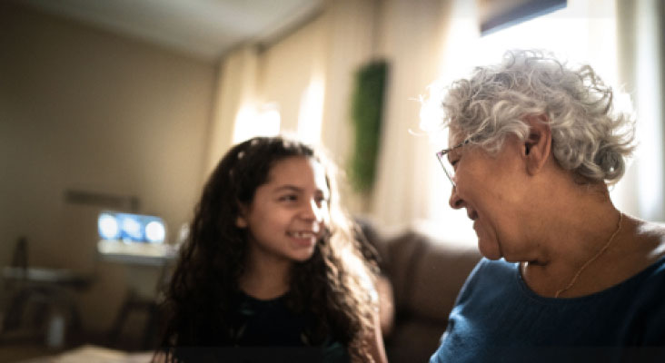 An elderly woman talking to her grandchild.