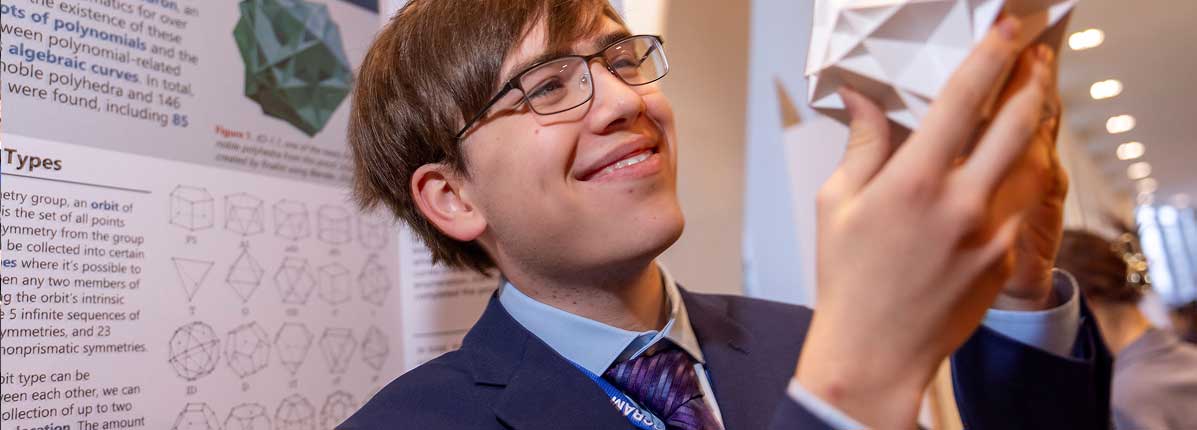 2026 Regeneron Science Talent Search winner Connor Hill holding a noble polyhedron